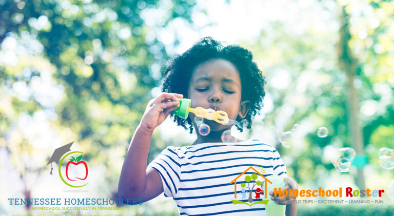 African girl blowing bubble in the park